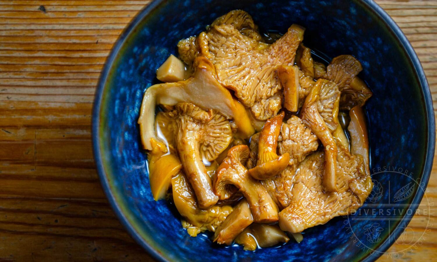 Pickled chanterelle mushrooms in a blue bowl