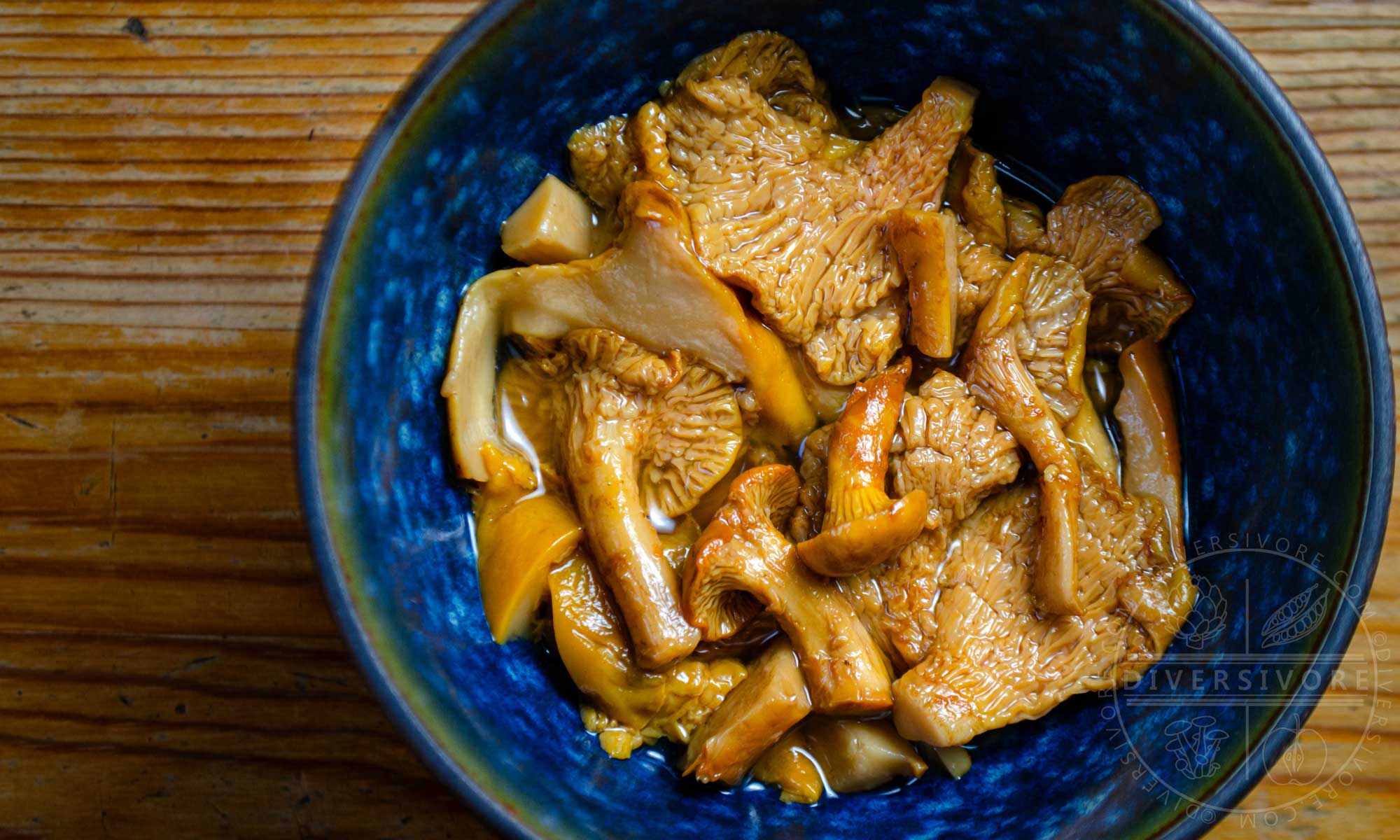 Pickled chanterelle mushrooms in a blue bowl